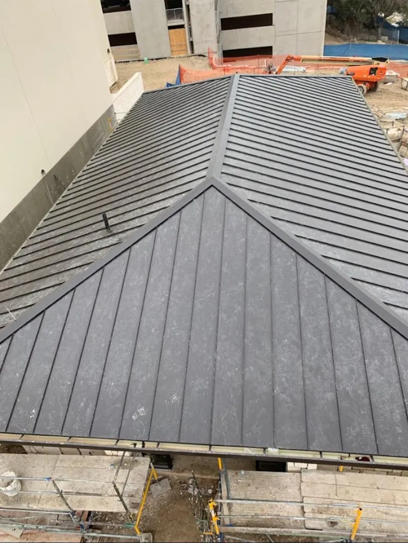 Commercial metal roof construction with crane equipment in Mount Vista