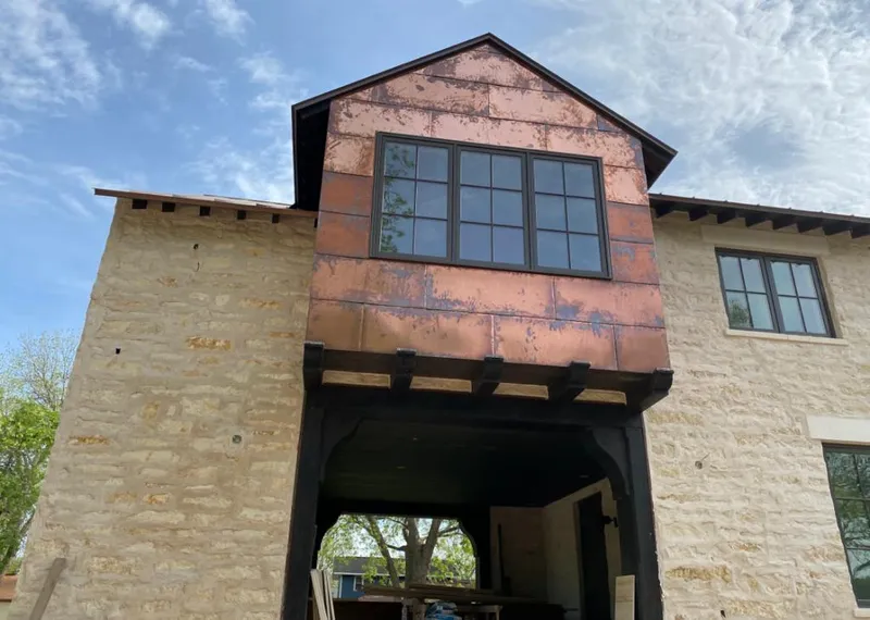 Copper metal panel facade on a stone building for Roof Repair in Mount Vista